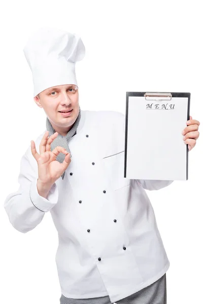 Young handsome chef with menu in hand on white background — Stock Photo, Image