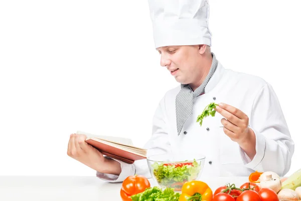 Horizontal portrait of the cook at the table with salad and a bo — Stock Photo, Image