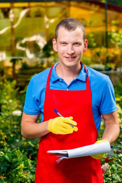 Businesswoman with folder in the greenhouse among plants — Stock Photo, Image
