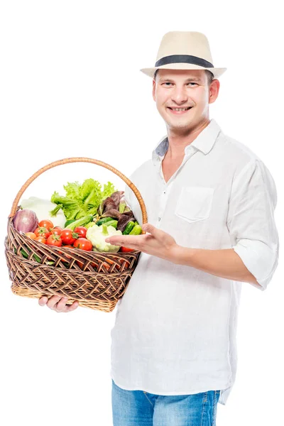 Smiling experienced farmer with a harvest of vegetables on a whi — Stock Photo, Image