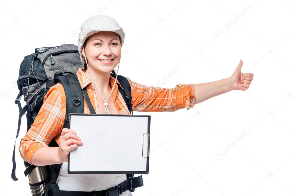 young woman tourist hitchhiking travels with a blank in hands