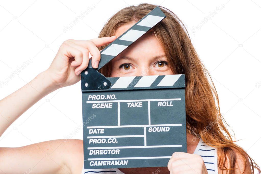 Close-up of an actress looking after a movie clapper on a white 