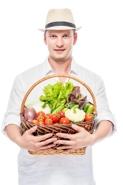 Man rural farmer with a harvest of vegetables on a white backgro — Stock Photo, Image