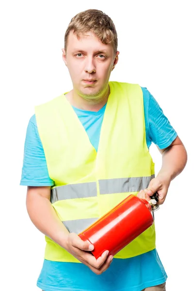 Worker in a vest with a fire extinguisher in hands on a white ba — Stock Photo, Image