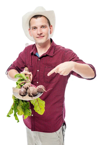 Gardener farmer laid on a spade of a beet crop, portrait on a wh — Stock Photo, Image