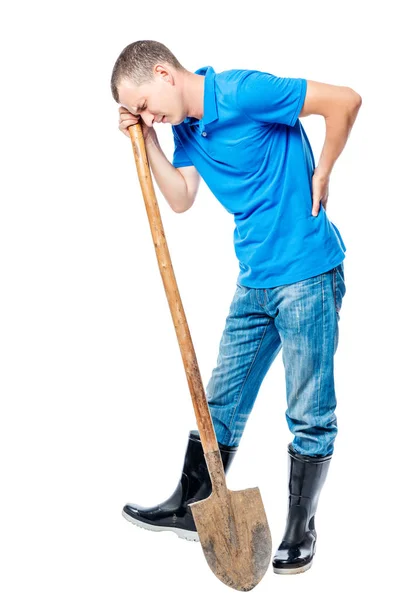 Granjero con una pala sosteniendo su mano una llaga en un bac blanco — Foto de Stock