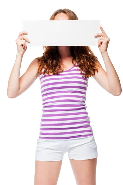 Red-haired girl hides her face behind the poster — Stock Photo, Image