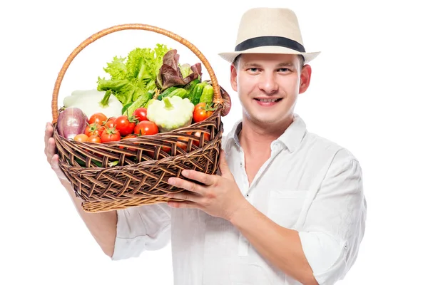 Happy experienced farmer with a harvest of vegetables in a baske — Stock Photo, Image