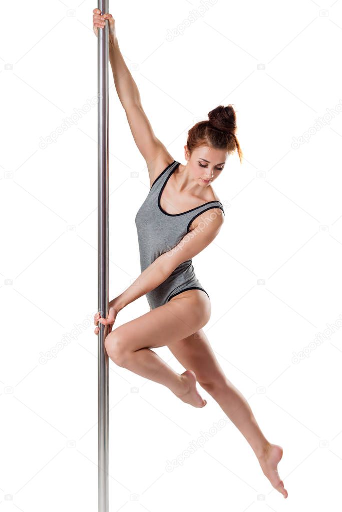 Beautiful pose of a girl on a pylon isolated on a white backgrou