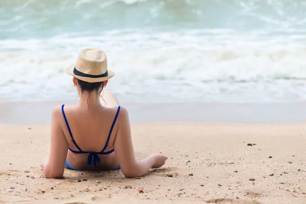 Woman in bikini resting on the beach looking at the sea with her — Stock Photo, Image