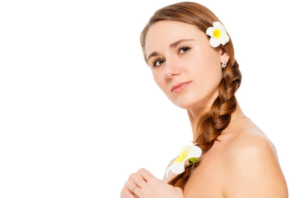 Woman with frangipani flowers in hair close-up portrait on white — Stock Photo, Image