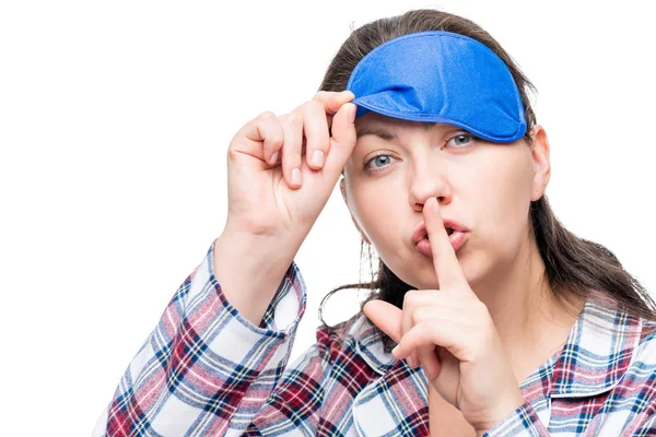 Woman in pajamas shows gesture behave silently on white backgrou — Stock Photo, Image