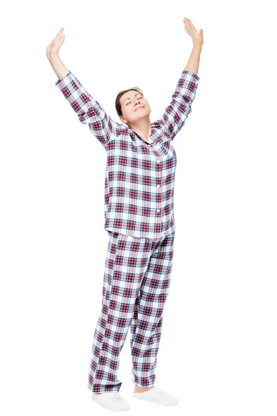 Menina esticada em pijama em um fundo branco em comprimento total — Fotografia de Stock