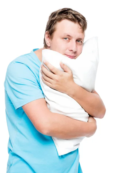 Retrato vertical de un hombre con una almohada suave sobre un fondo blanco — Foto de Stock