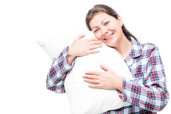 Happy brunette in pajama hugs soft pillow against white backgrou — Stock Photo, Image