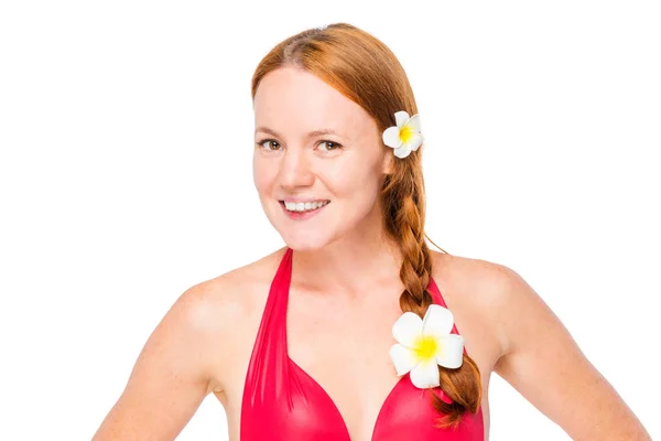 Beautiful woman with red hair with flowers of plumer in bikini o — Stock Photo, Image
