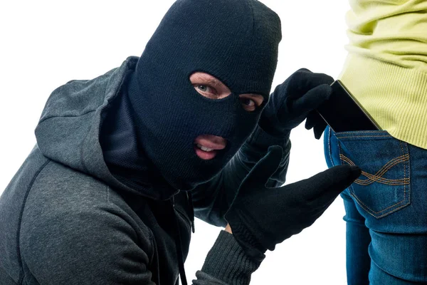 Stealing phone from the back pocket jeans in the mask — Stock Photo, Image