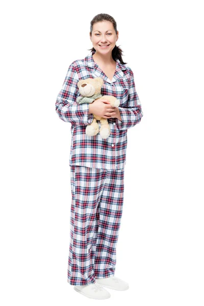 Женщина в пижаме с плюшевым мишкой на белом фоне в полном лен — стоковое фото