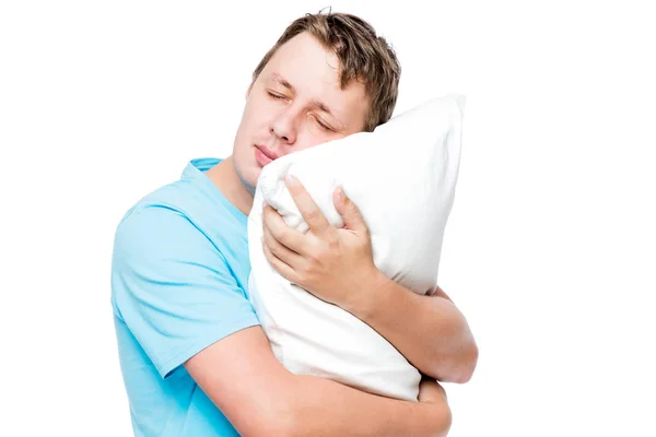 Homem adormecido abraçando travesseiro macio contra fundo branco — Fotografia de Stock