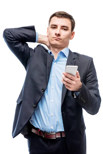 Empresário cansado com telefone na mão no fundo branco — Fotografia de Stock