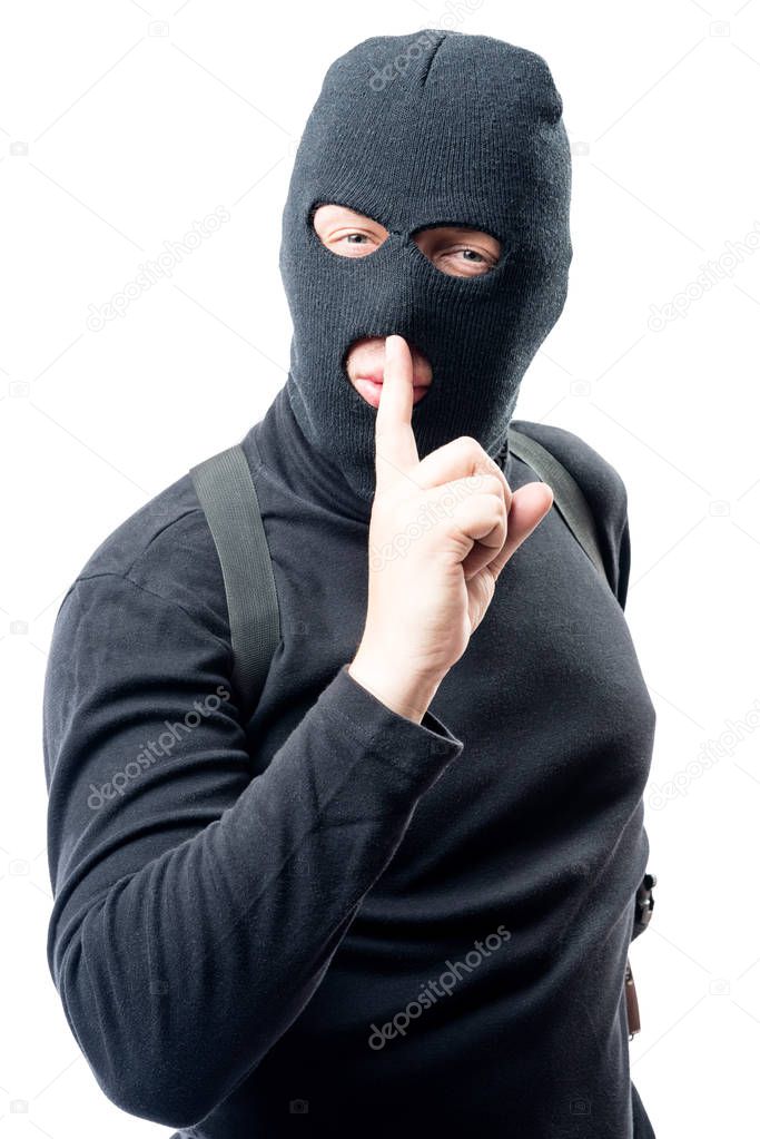 criminal shows his hand a finger near his lips asking for a quie