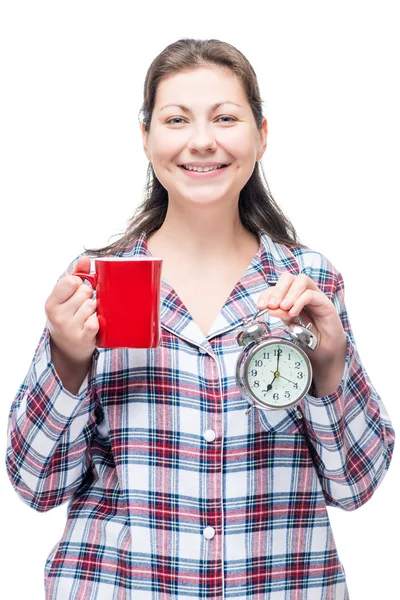 Brunette in pajamas with a mug of coffee and an alarm clock in t — Stock Photo, Image