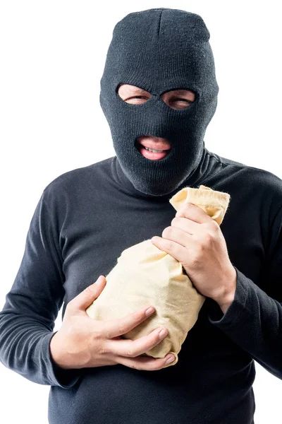 Ladrão em uma máscara com um saco de dinheiro em um fundo branco — Fotografia de Stock