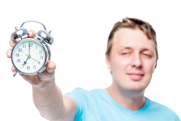 Portrait of a man outside focus, hand with an alarm clock in foc — Stock Photo, Image