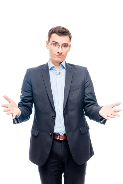 Young man in glasses and suit on white background posing in stud — Stock Photo, Image