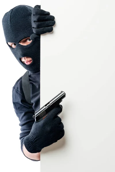 The criminal with the gun points to the space on the poster — Stock Photo, Image