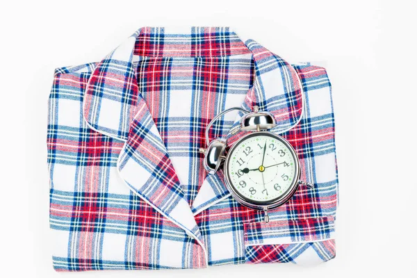 Classic pajama shirt and alarm clock on white background — Stock Photo, Image