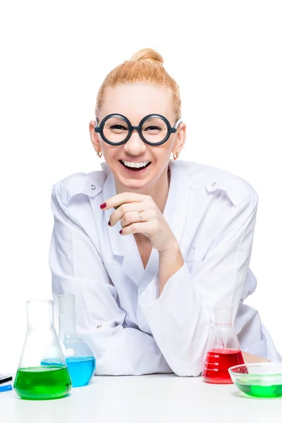 Cheerful laughing assistant in glasses and a lab coat with test — Stock Photo, Image