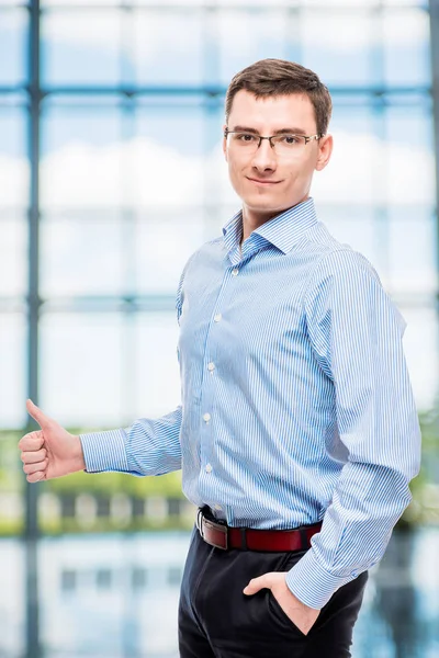 Successful businessman in a shirt extends a hand for greetings in office — Stock Photo, Image