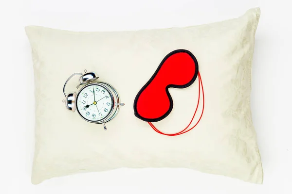 Mask for sleep and alarm clock on the feather pillow top view of — Stock Photo, Image