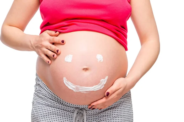 Op witte achtergrond buik van een zwangere vrouw close-up met een pa Stockafbeelding