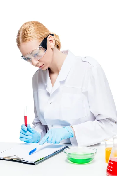 Portrait of a chemist in a protective uniform at the table worki — Stock Photo, Image