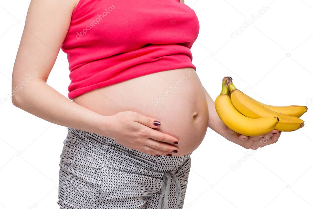 Ripe bananas in the palm of a pregnant woman, photo without a fa