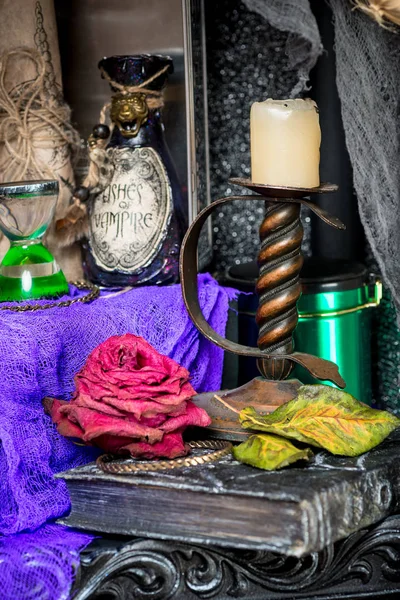 Candlestick closeup on a table with a witch's props for rituals — Stock Photo, Image