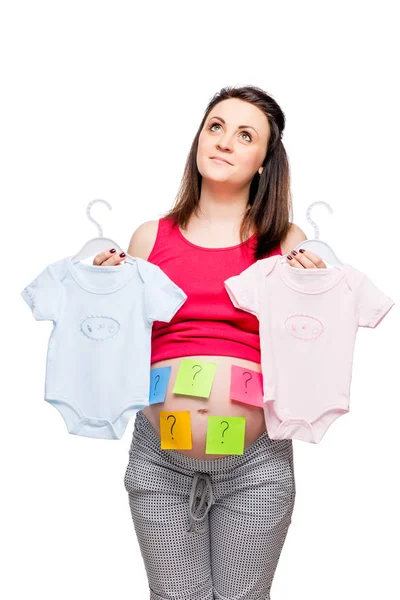 Dreamy woman with clothes for boy and girl conceptual photo — Stock Photo, Image