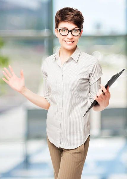 Happy woman in glasses with a folder in the office rejoices — Stock Photo, Image