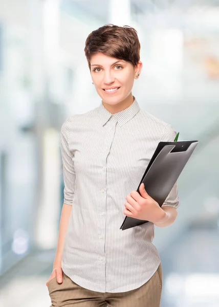 Accountant young girl with a folder in the office — Stock Photo, Image