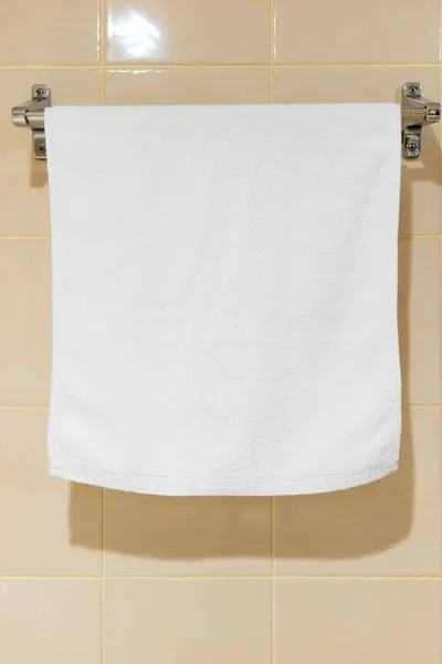 White terry towel hanging in the bathroom on the drier — Stock Photo, Image