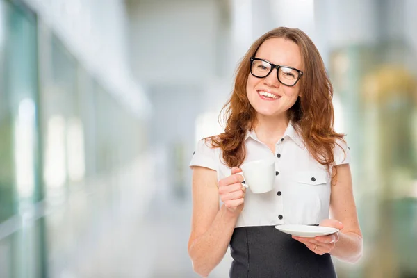 Office worker with a cup of coffee, left space in the office — Stock Photo, Image