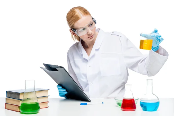 Pretty young chemist makes tests of substances in test tubes, po — Stock Photo, Image