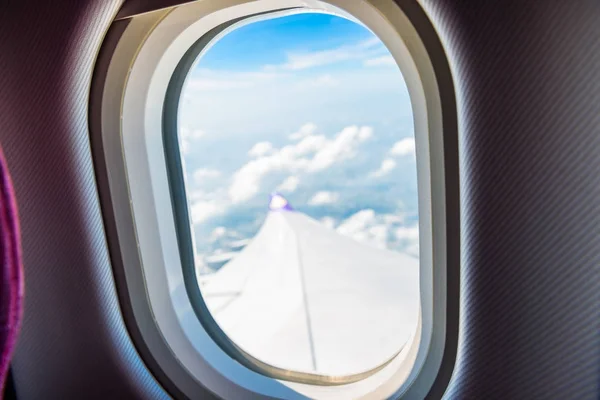 Aircraft window close-up view from the window is out of focus — Stock Photo, Image