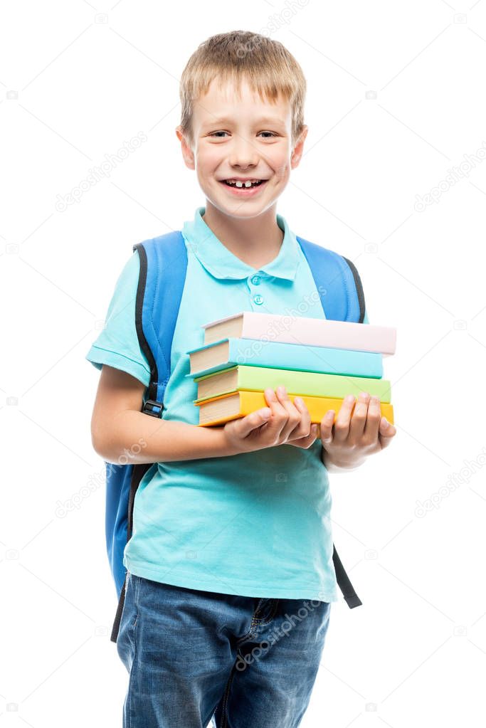 happy schoolboy 8 years old with books on white background
