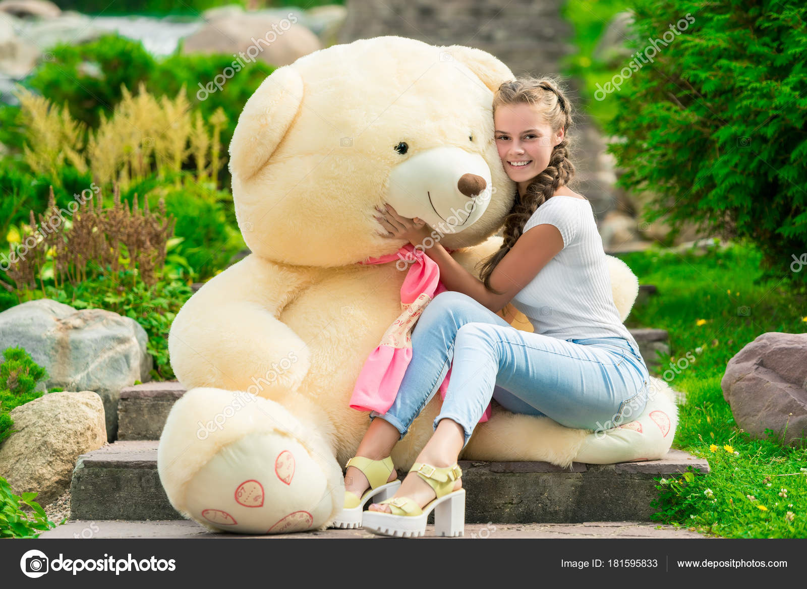 girl hugging huge teddy bear