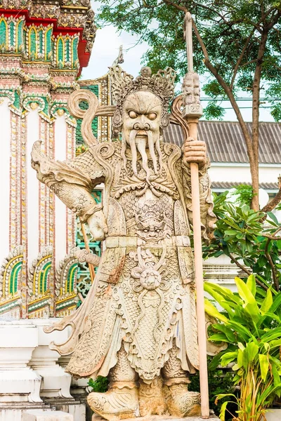 A terrible stone guard is located near the temple in Bangkok — Stock Photo, Image