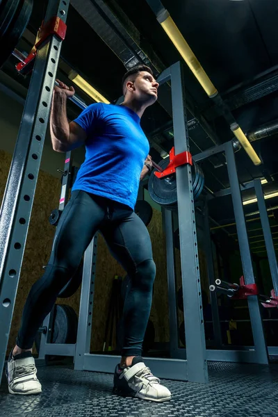 Forte atleta in allenamento in palestra, un uomo solleva un pesante ardiglione — Foto Stock