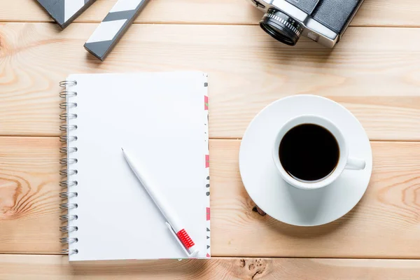 A notebook on springs from above, a cup of coffee and objects fo — Stock Photo, Image